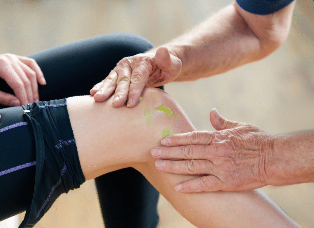 Doctor applying Body Guac topical cream to an elderly patient's shoulder for natural pain relief